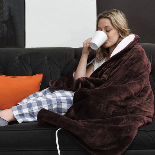 Coffee electric heated flannel throw blanket on a sofa