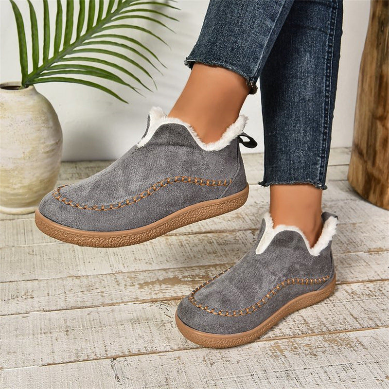 Dark grey fleece-lined slip-on ankle booties, worn