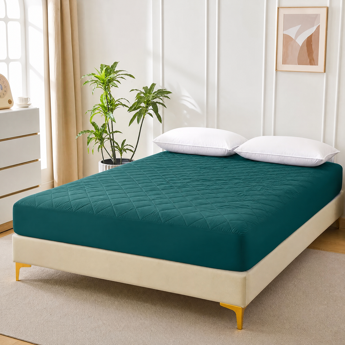 Teal green quilted waterproof mattress protector fitted on a bed in a bright bedroom