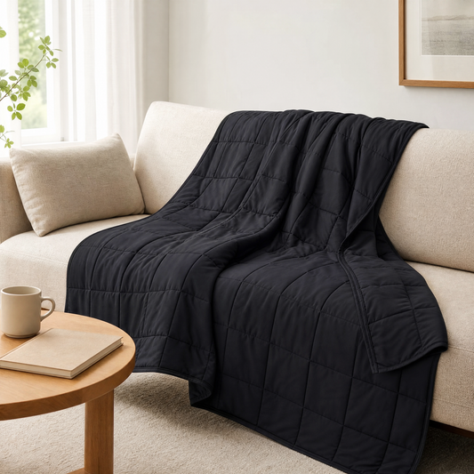 Weighted blanket draped over a sofa in a bright living room