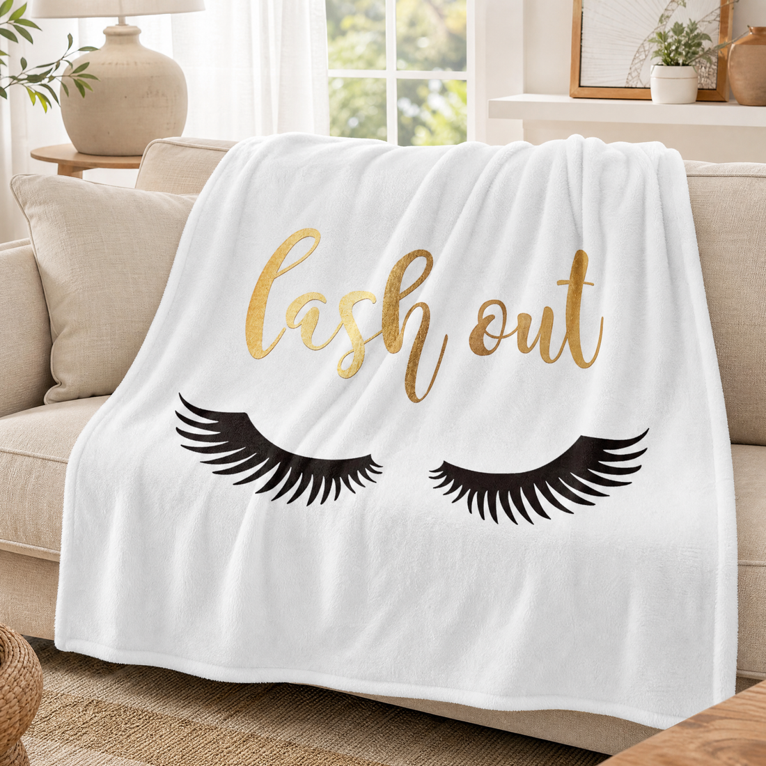 Plush fluffy throw blanket with eyelash print draped over a sofa in a bright living room