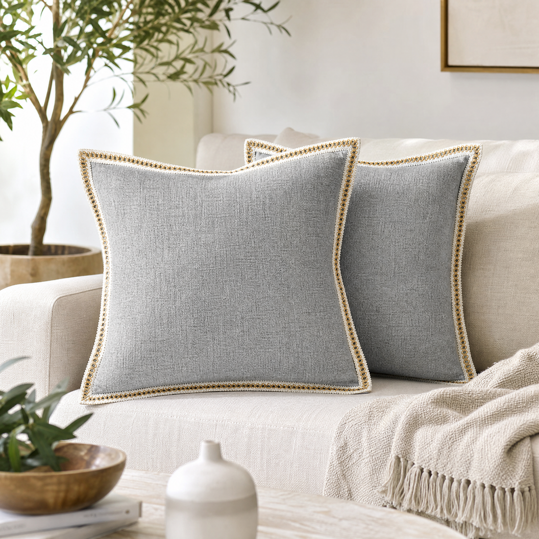 Pair of linen throw pillow covers on cushions on a linen sofa
