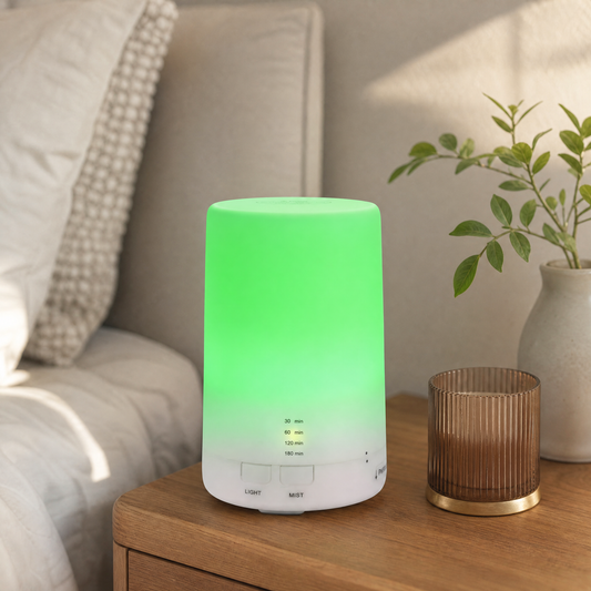 Mini cool mist humidifier and essential oil diffuser on a bedside table