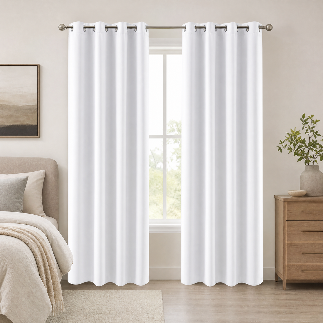 White thermal room darkening curtains with grommets hanging in a calm bedroom