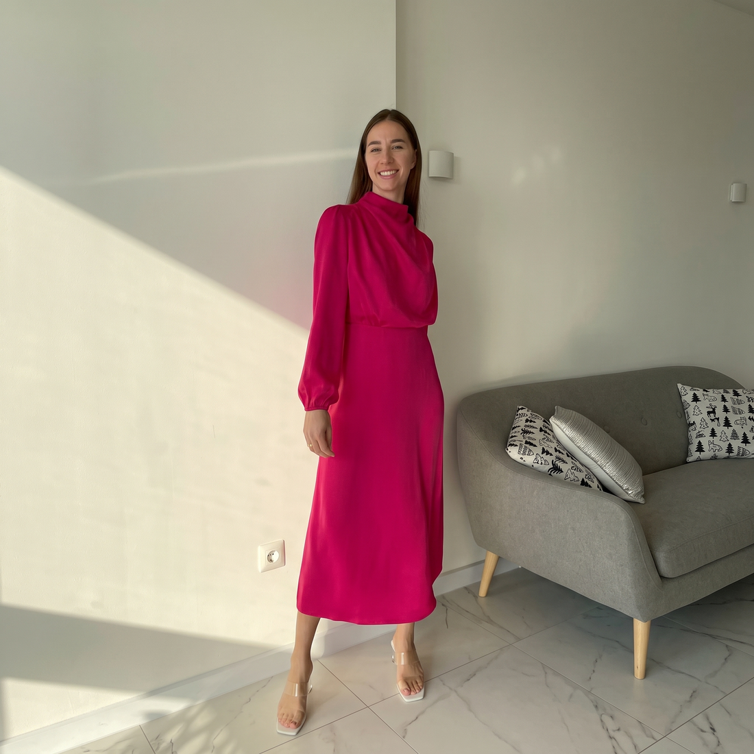 Woman wearing the rose red satin mock neck midi dress at home